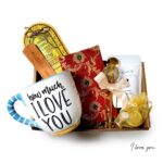 Spiritual gift box with incense, incense holder, mug, honey, tea, and notebook